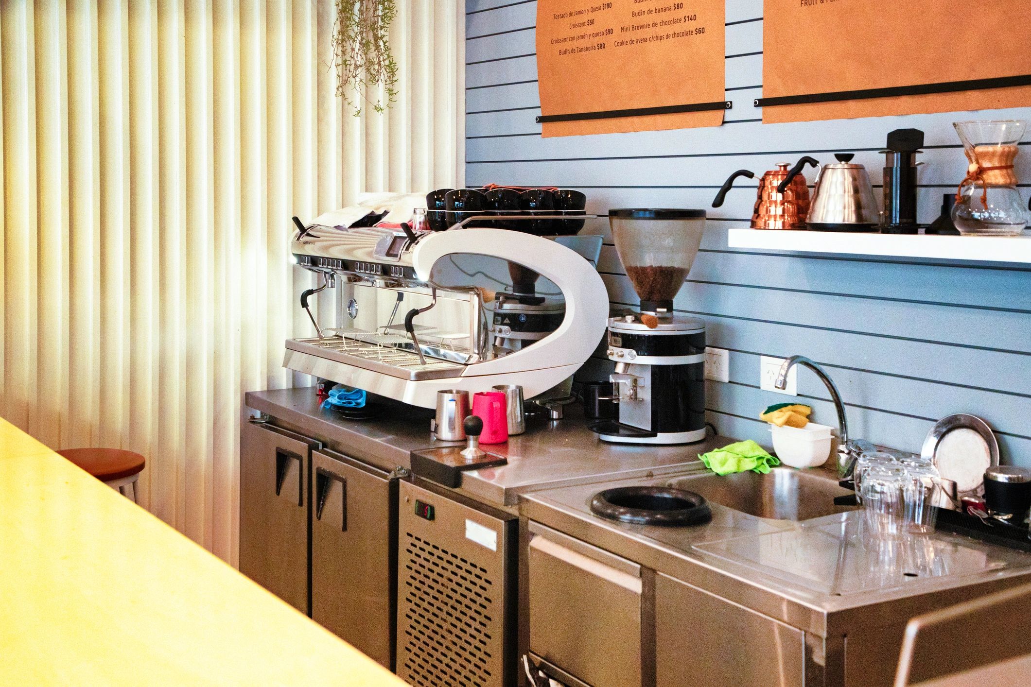 Coffee making equipment counter and sink in small cafe