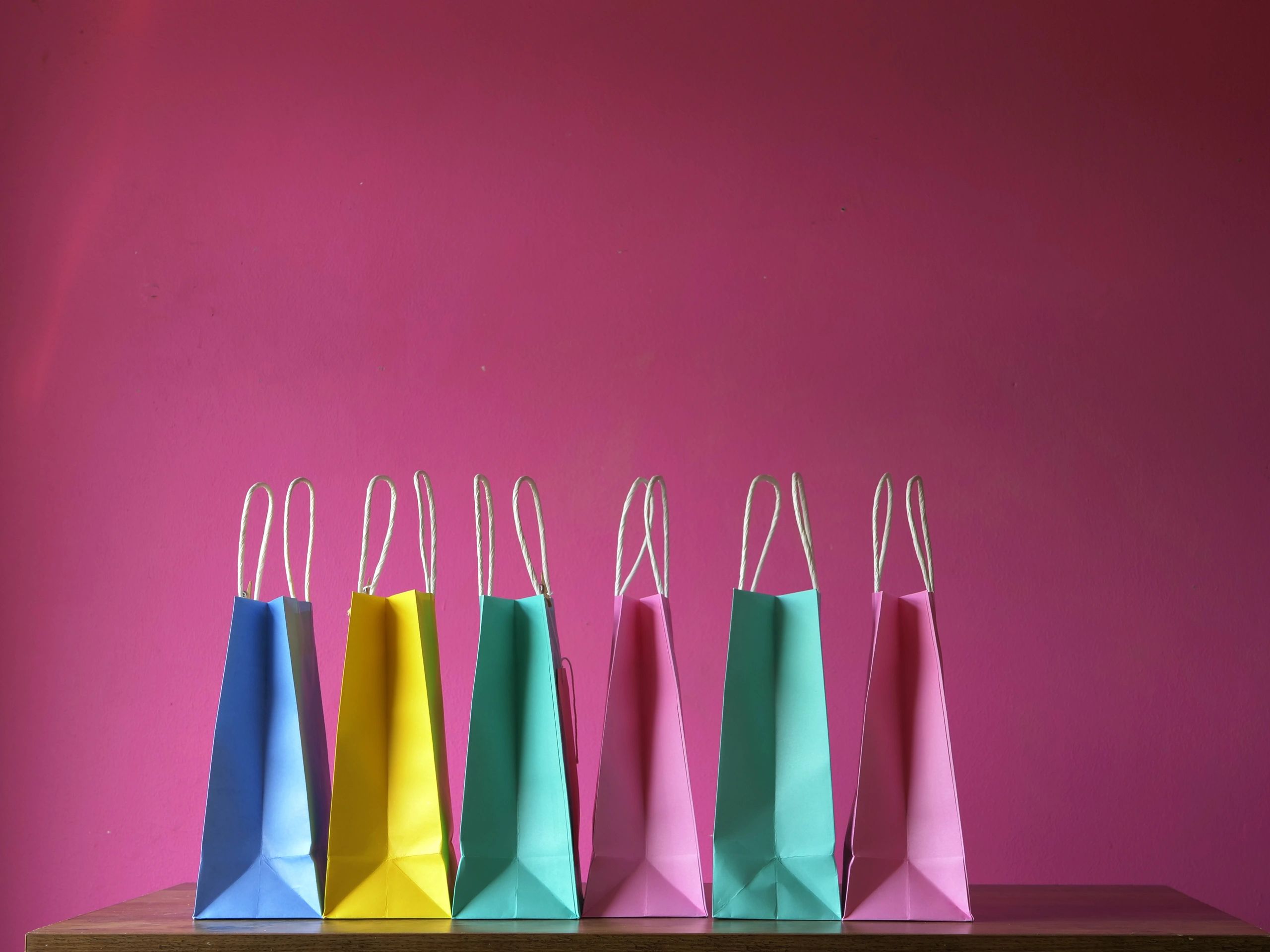 Gift bags arranged in a row for branded event packaging inspiration