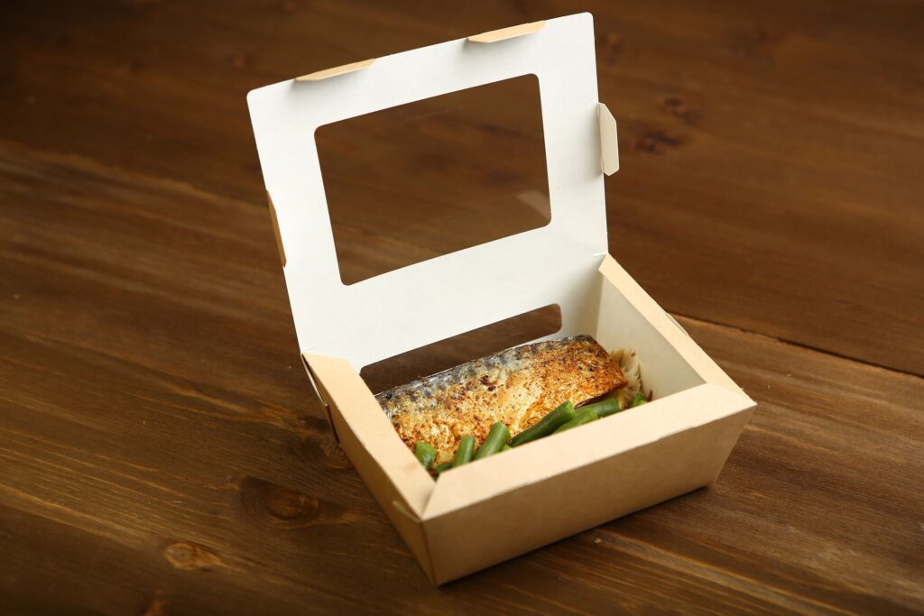 Delivery of healthy and proper nutrition, fish and vegetables on the grill in a box