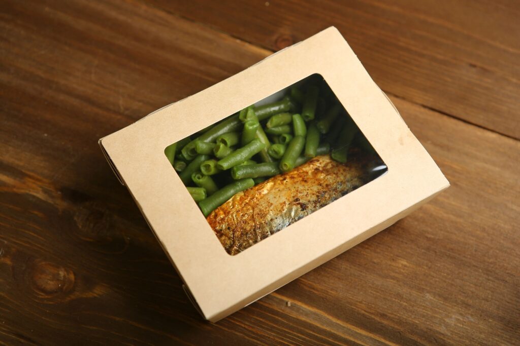Delivery of healthy and proper nutrition, fish and vegetables on the grill in a box